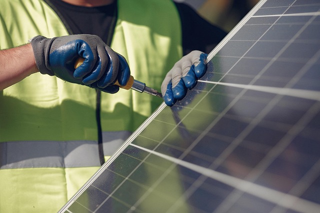 Solar installer working with photovoltaic panels